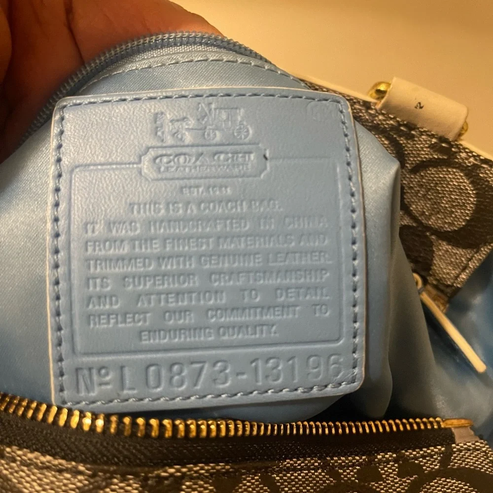 Coach bag gray and black with blue and white stripes gold logo in the front_14